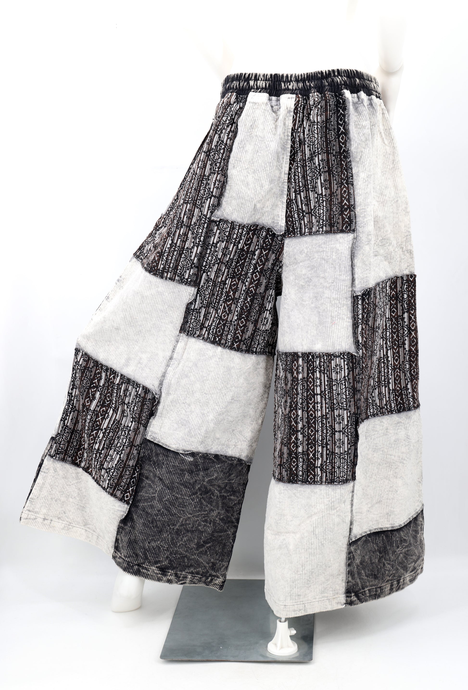 Backside of a patchwork pants on a mannequin against a white background