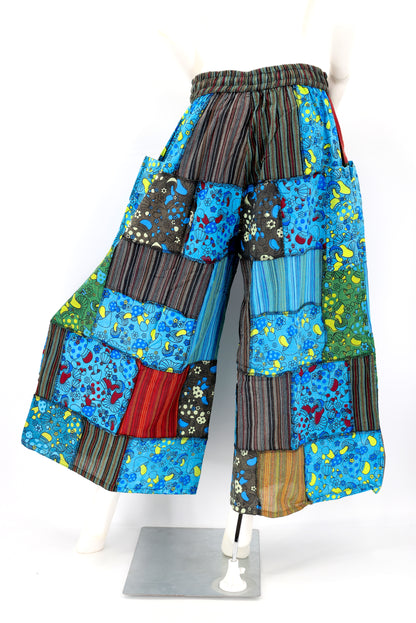 Back profile of hippie-style harem trousers with mushroom embroidery and wide-leg fit