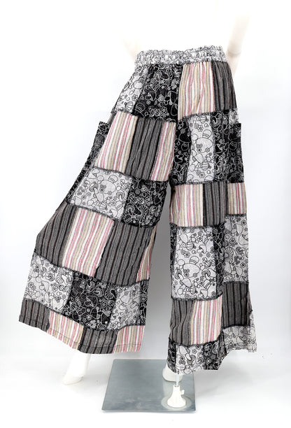 Back profile of hippie-style harem trousers with mushroom embroidery and wide-leg fit