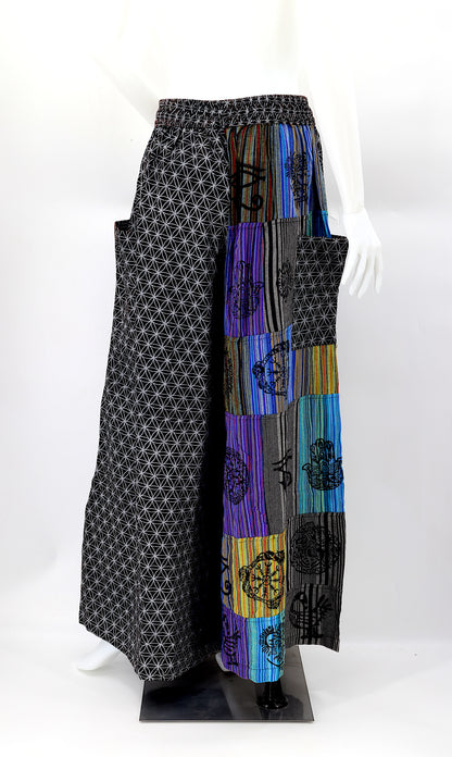 Back view of unique patchwork design featuring pagan symbols on wide-leg cotton harem trousers