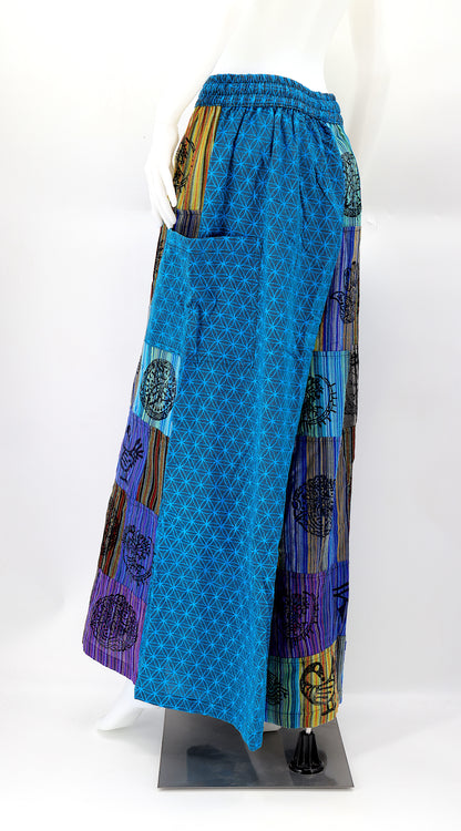 Back view of unique patchwork design featuring pagan symbols on wide-leg cotton harem trousers