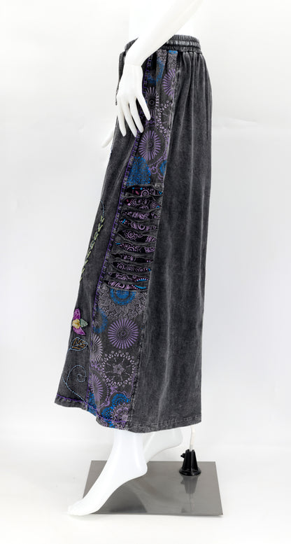 Side view of wide-leg pants showing deep functional pockets and flowing silhouette.