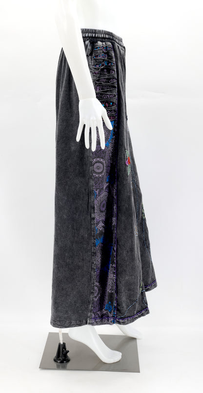 Side view of wide-leg pants showing deep functional pockets and flowing silhouette.