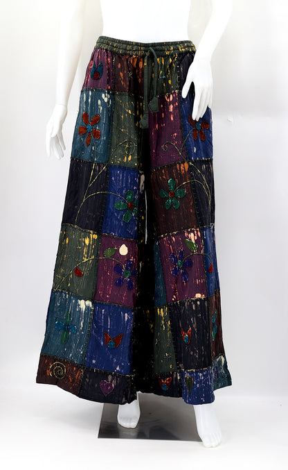 Front view of handmade flower embroidered patchwork wide-leg cotton harem pants