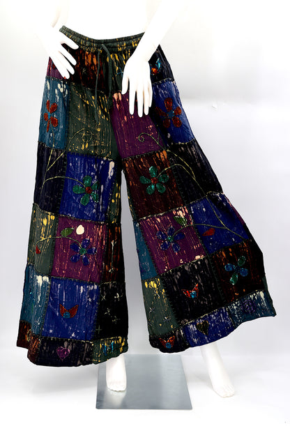 Front view of handmade flower embroidered patchwork wide-leg cotton harem pants